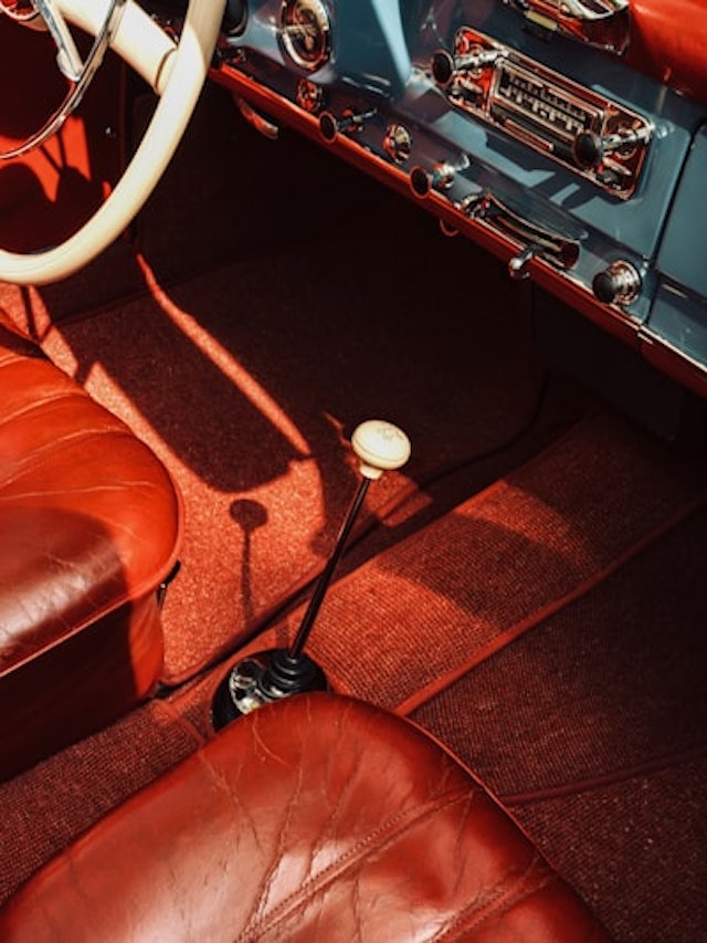 the interior of a classic car with leather seats